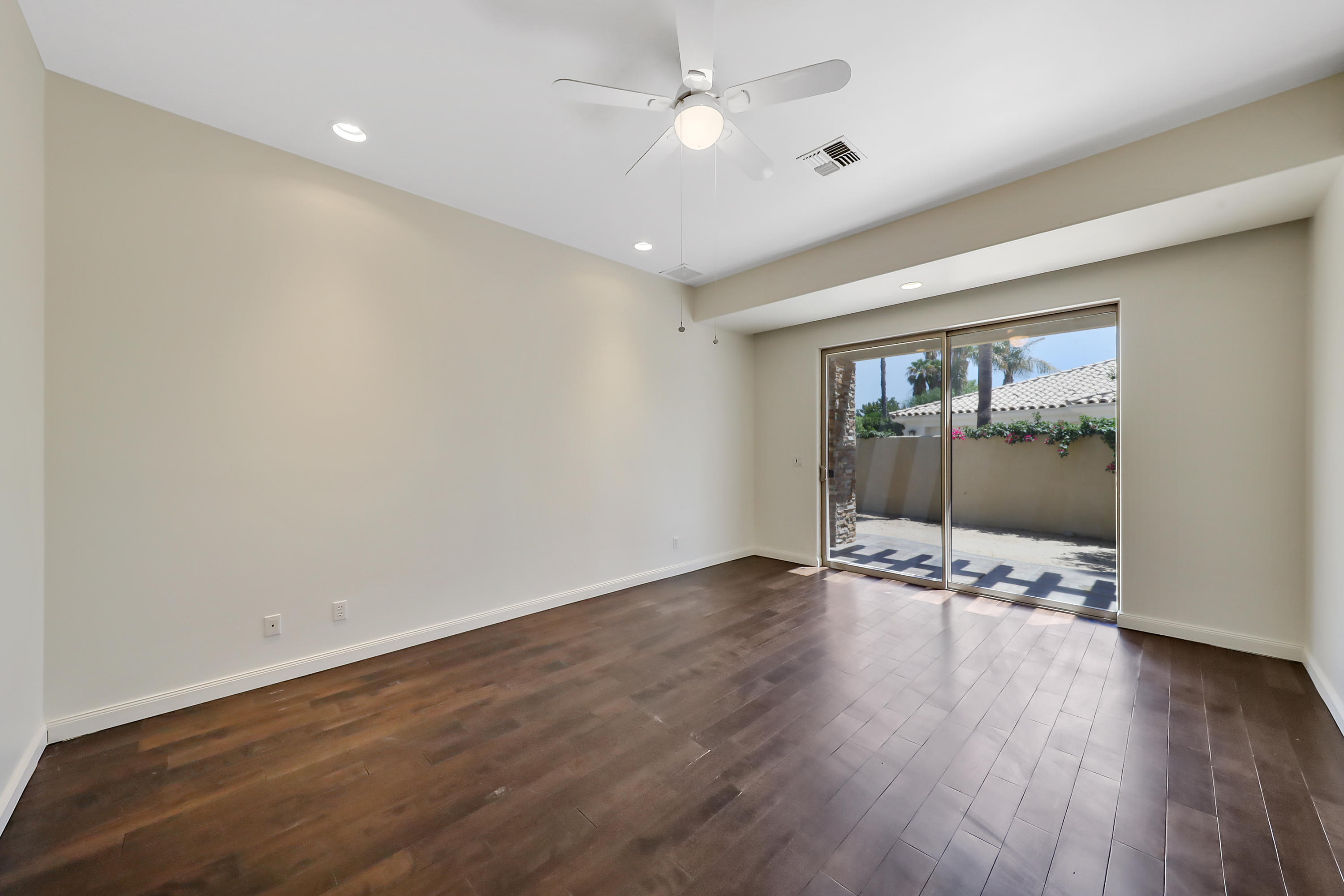 28 Clancy Lane South Rancho Mirage, CA 92270 - Photo 20 of 30 a view of an empty room with wooden floor and a window