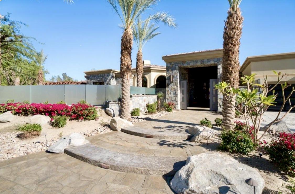 28 Clancy Lane South Rancho Mirage, CA 92270 - Photo 4 of 30 a view of a house with a yard and a bench