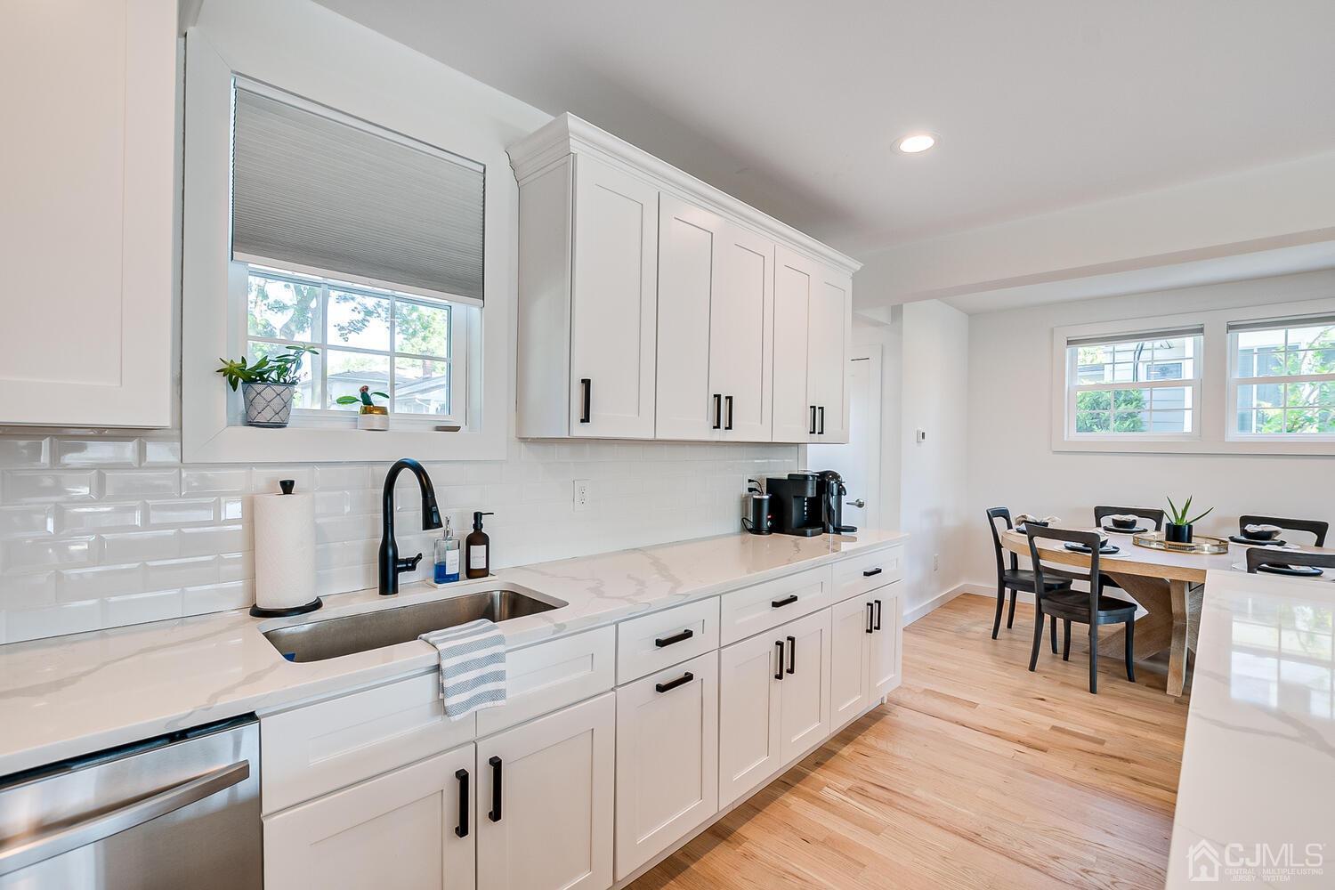 31 Carlton Street Edison, NJ 08837 - Photo 25 of 64 a kitchen with white cabinets and sink
