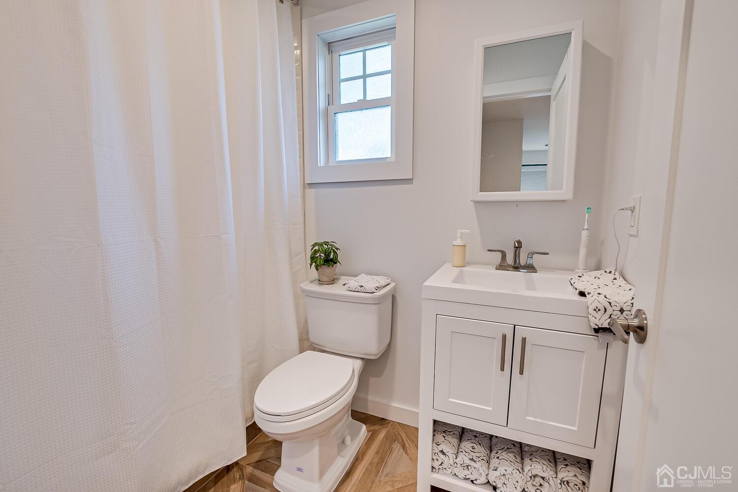 31 Carlton Street Edison, NJ 08837 - Photo 36 of 64 a white toilet sitting next to a bathroom sink