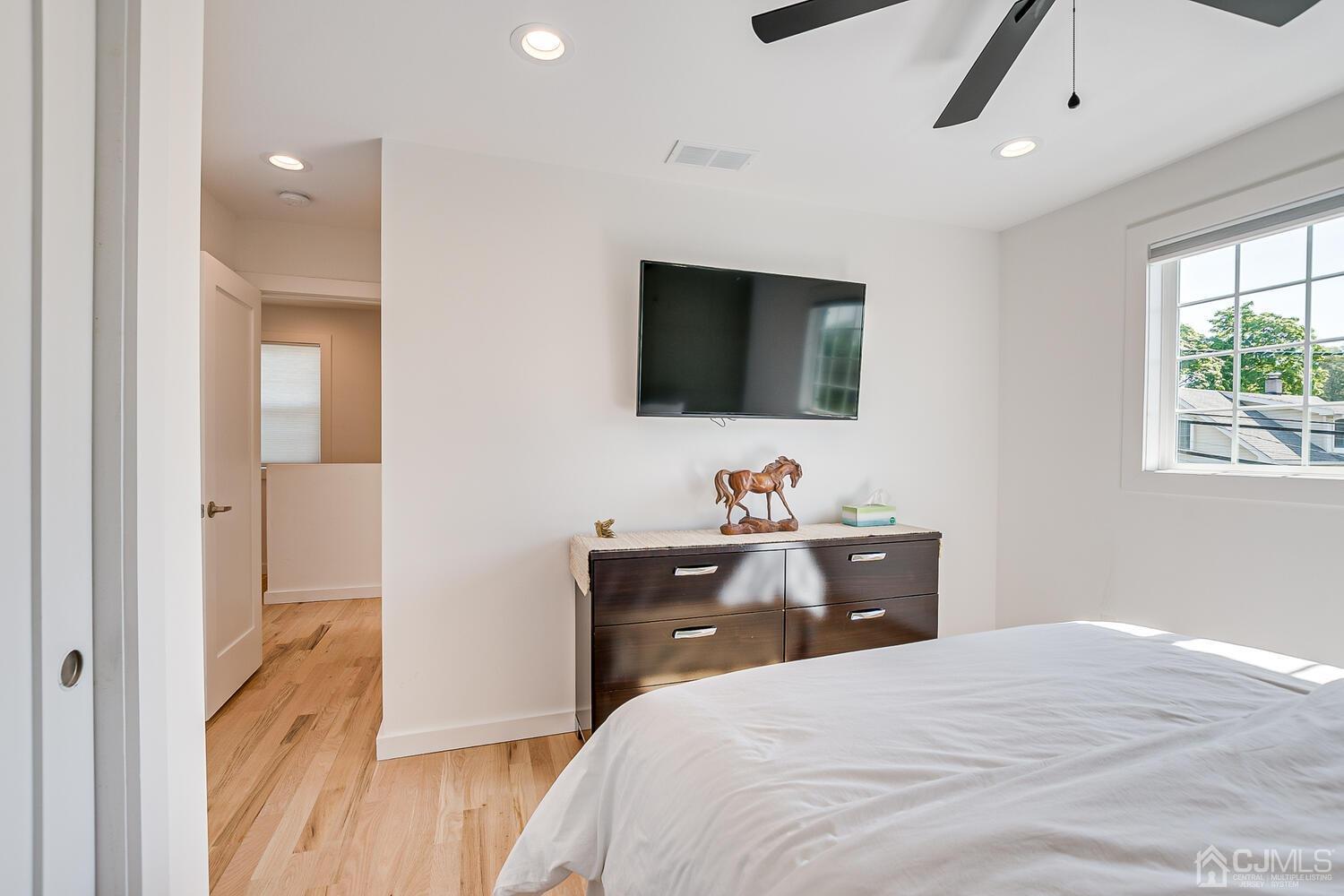31 Carlton Street Edison, NJ 08837 - Photo 39 of 64 a bedroom with a bed and a flat screen tv