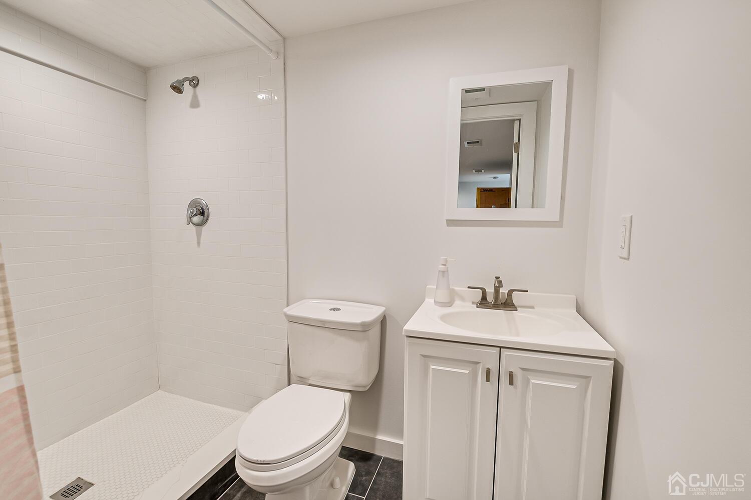 31 Carlton Street Edison, NJ 08837 - Photo 48 of 64 a bathroom with a toilet sink vanity and mirror