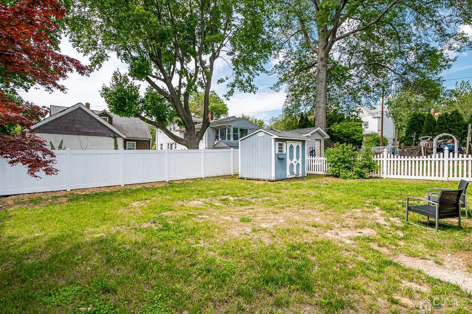 31 Carlton Street Edison, NJ 08837 - Photo 54 of 64 a view of a house with a backyard and a tree