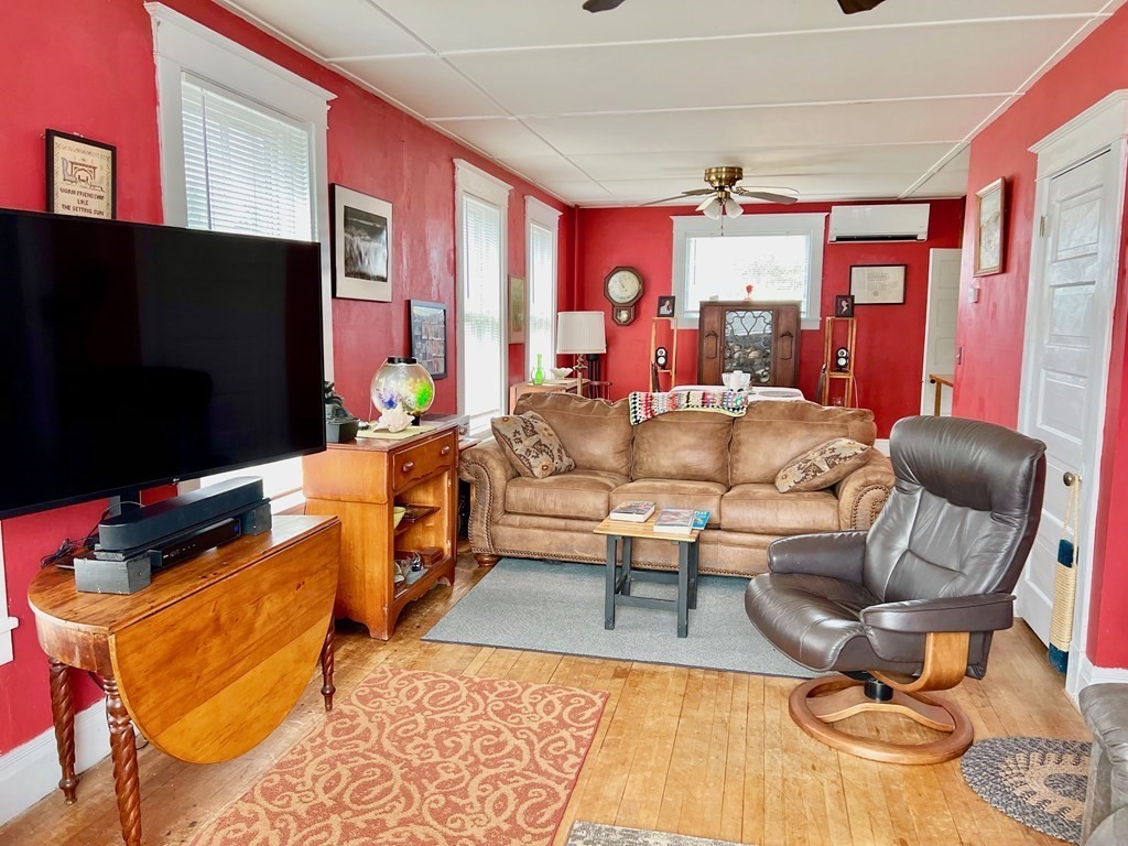 278 Birnam Road Northfield, MA 01360 - Photo 15 of 36 a living room with furniture a flat screen tv and floor to ceiling window