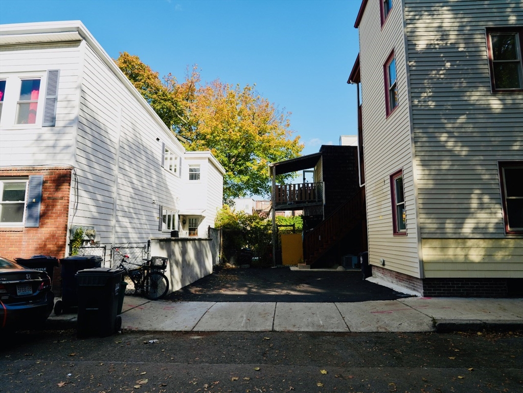 59 7th Street, Unit 1 Cambridge, MA 02141 - Photo 21 of 21 a front view of a house with a yard