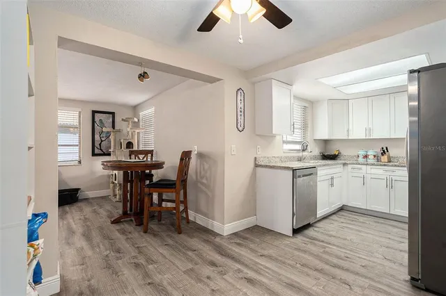 a view of kitchen with cabinets and wooden floor