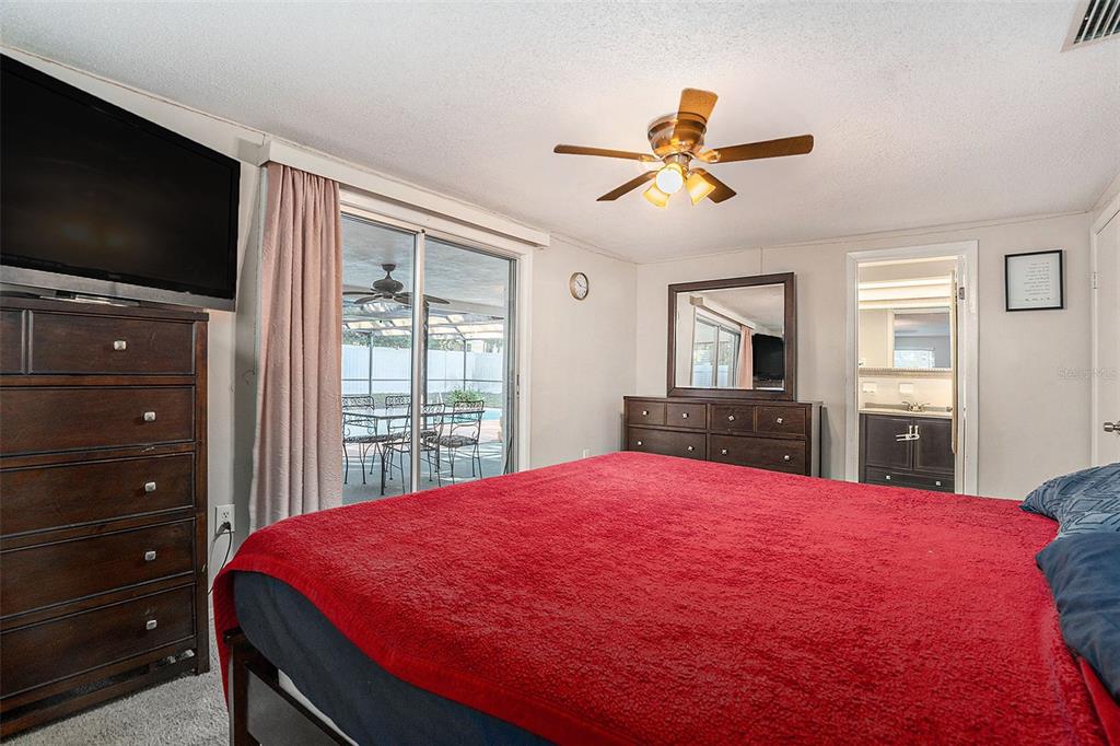 6406 Pawling Avenue Port Richey, FL 34668 - Photo 21 of 28 a bed room with a bed and a flat screen tv