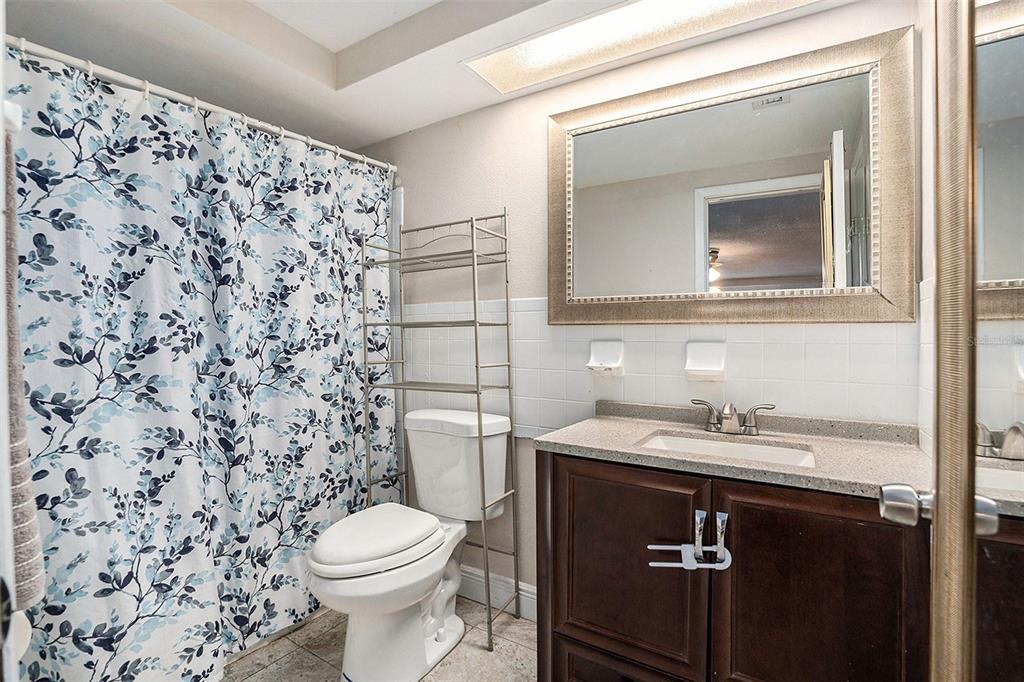 6406 Pawling Avenue Port Richey, FL 34668 - Photo 22 of 28 a bathroom with a sink toilet and mirror
