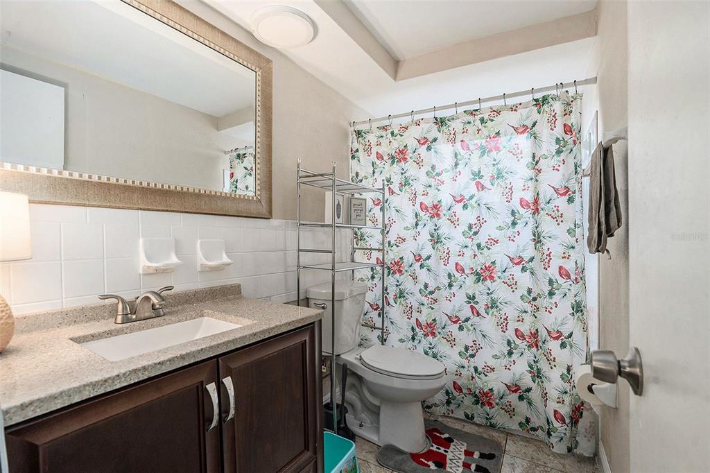 6406 Pawling Avenue Port Richey, FL 34668 - Photo 23 of 28 a bathroom with a sink toilet and shower