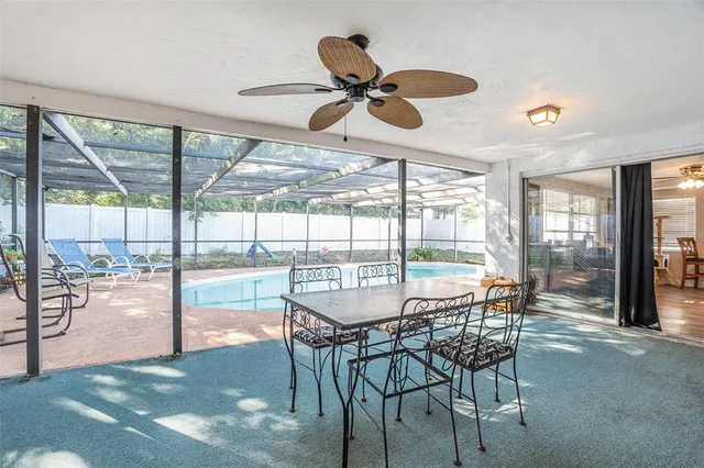 a dining room with furniture water view and a floor to ceiling window