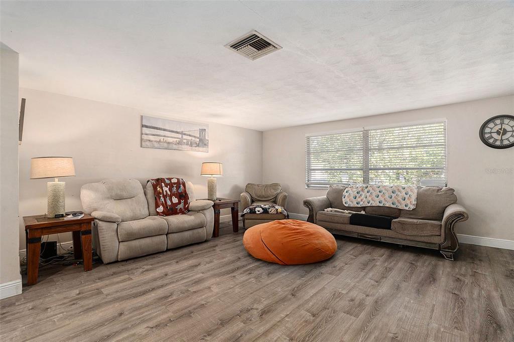 6406 Pawling Avenue Port Richey, FL 34668 - Photo 9 of 28 a living room with furniture and a large window