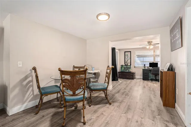 a view of a dining room with furniture and wooden floor