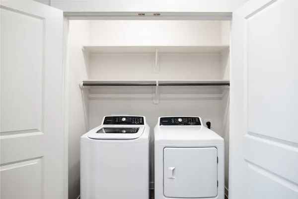 a view of storage and utility room with washer and dryer