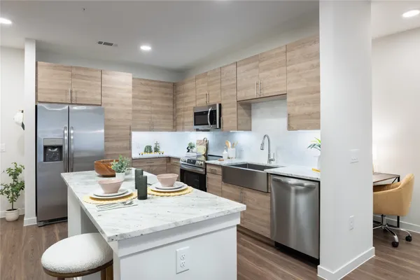 a kitchen with a sink a stove and chairs