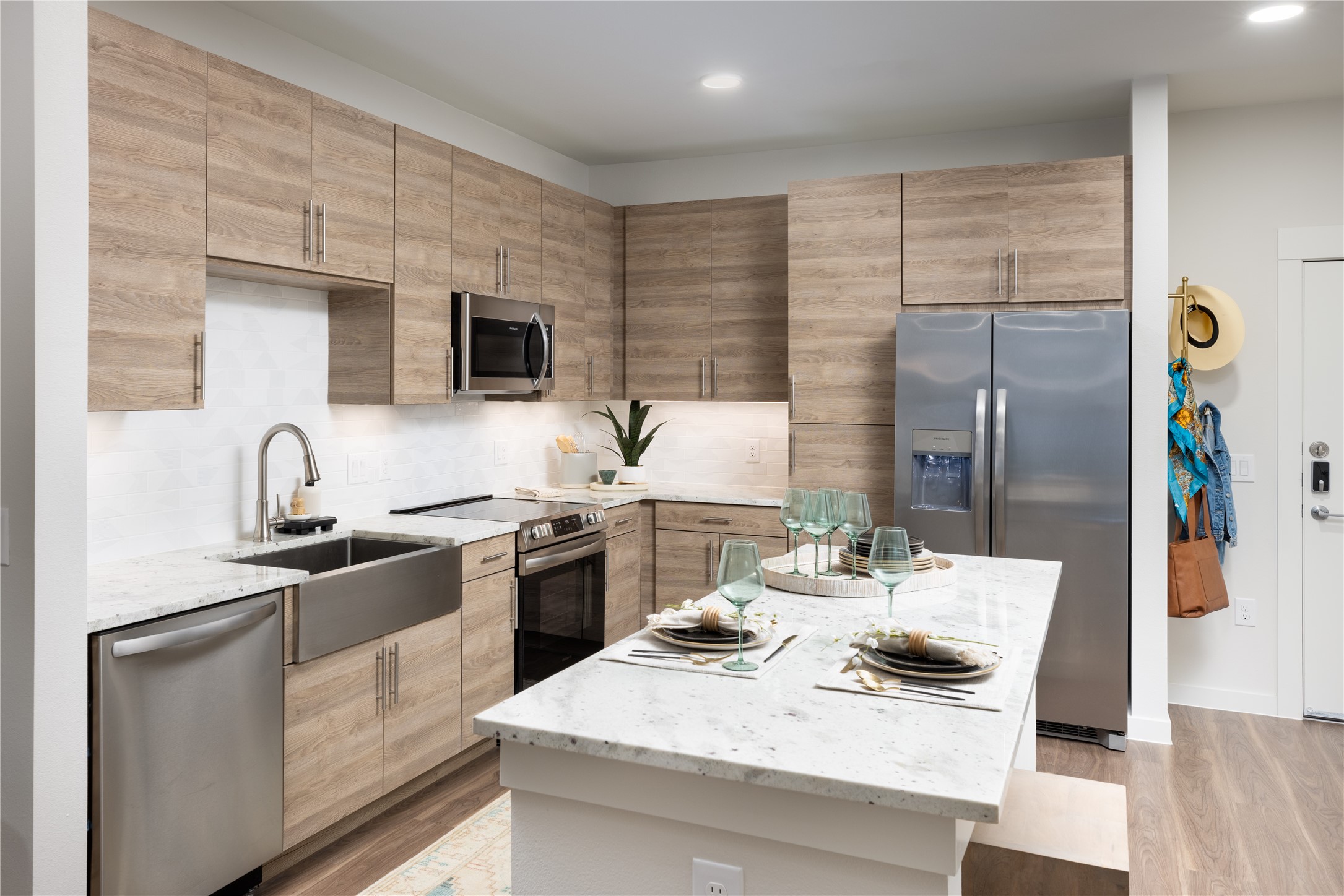 9302 Fry Road, Unit B2Y618 Cypress, TX 77433 - Photo 4 of 14 a kitchen with stainless steel appliances kitchen island granite countertop a sink and cabinets