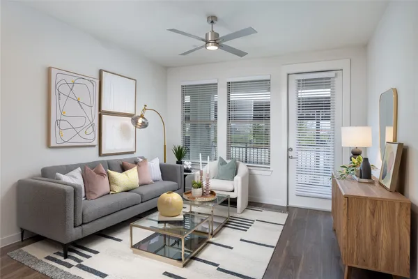 a living room with furniture and floor to ceiling windows
