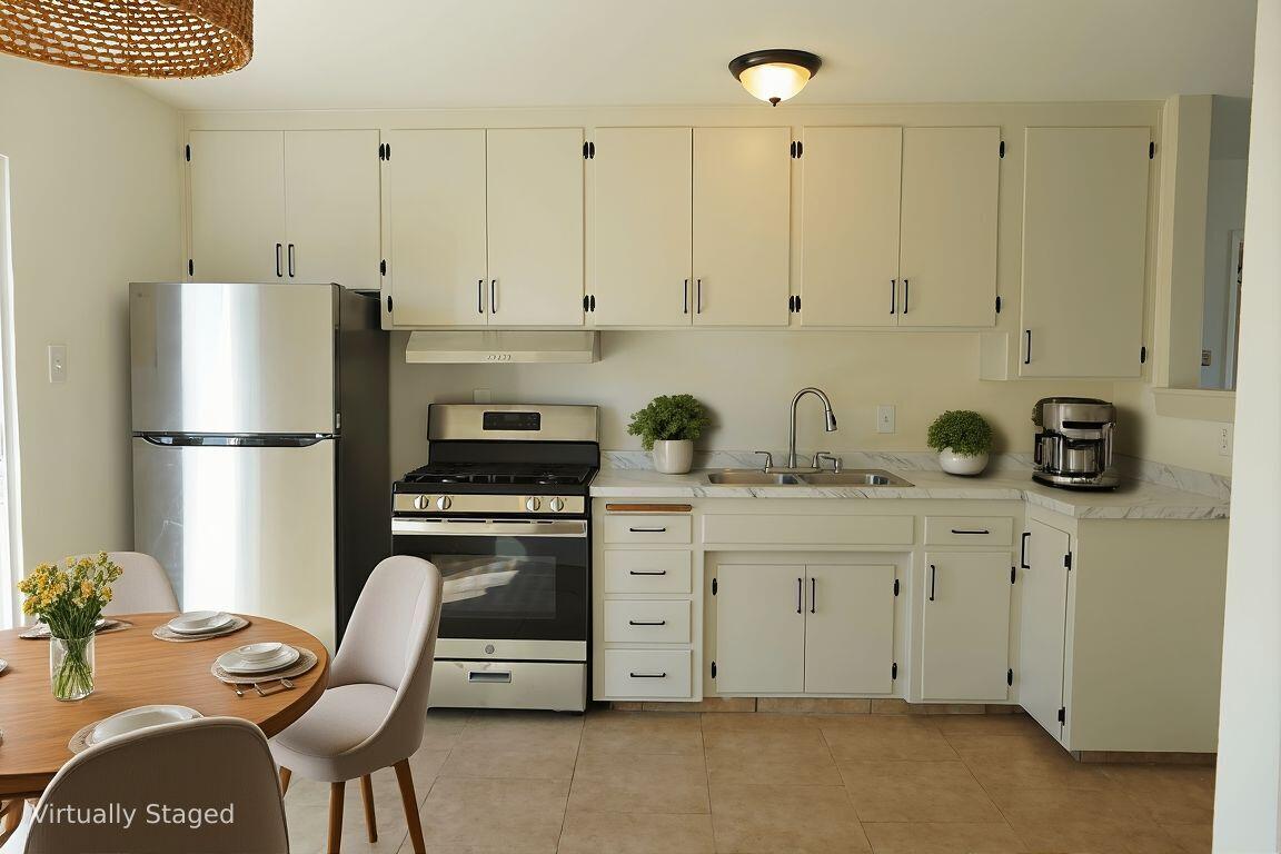 1100 North Third Street Lompoc, CA 93436 - Photo 4 of 12 a kitchen with stainless steel appliances granite countertop a refrigerator sink and cabinets