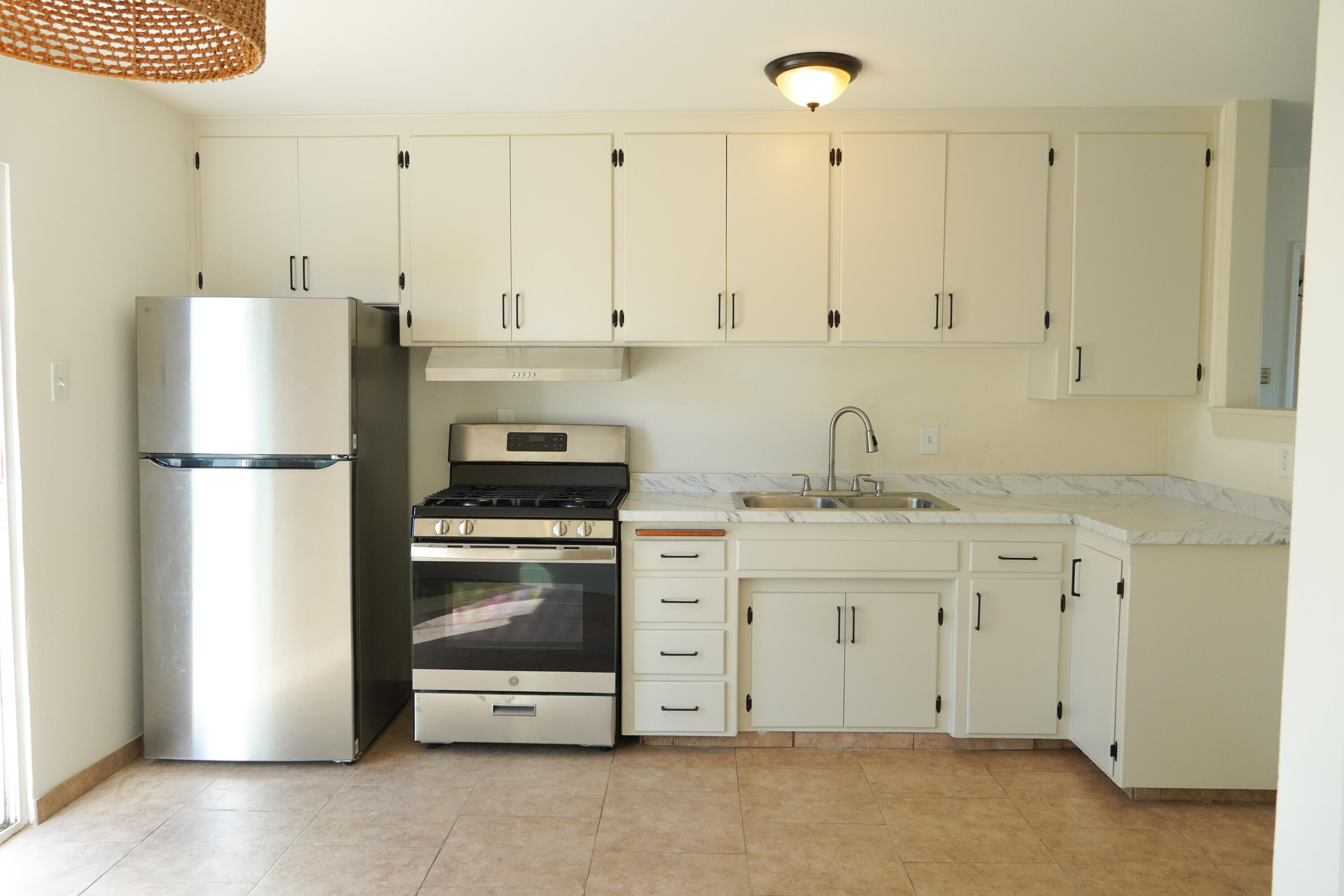 1100 North Third Street Lompoc, CA 93436 - Photo 5 of 12 a kitchen with appliances a sink and cabinets