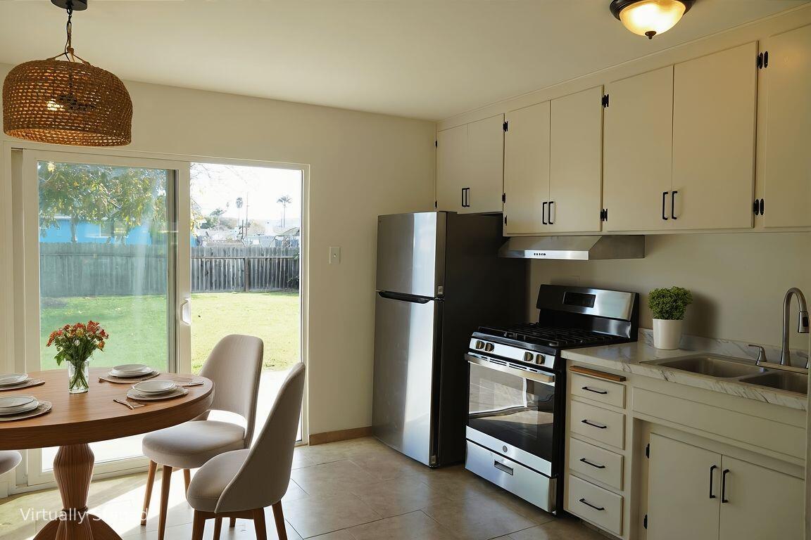 1100 North Third Street Lompoc, CA 93436 - Photo 6 of 12 a kitchen with stainless steel appliances granite countertop a refrigerator and a stove top oven