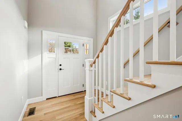 a view of staircase with white walls and a window