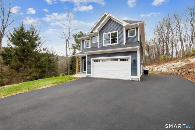 a view of an house with backyard and parking