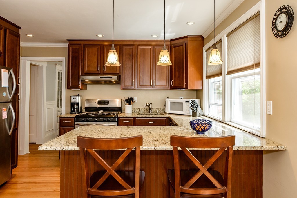 a kitchen with stainless steel appliances granite countertop a stove a refrigerator and a sink