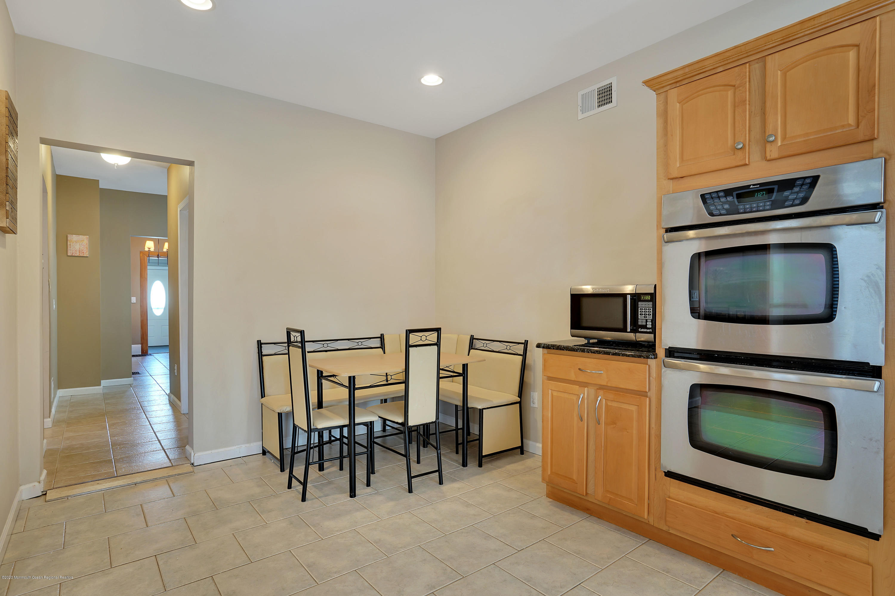 115 Harding Road Red Bank, NJ 07701 - Photo 22 of 43 a kitchen with stainless steel appliances granite countertop a stove top oven a sink a dining table and chairs