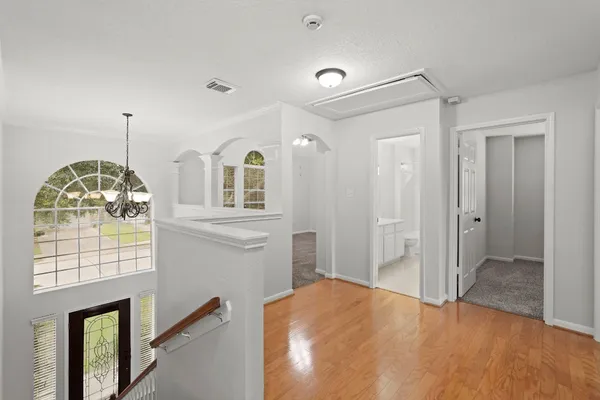 a view of hall way with mirror