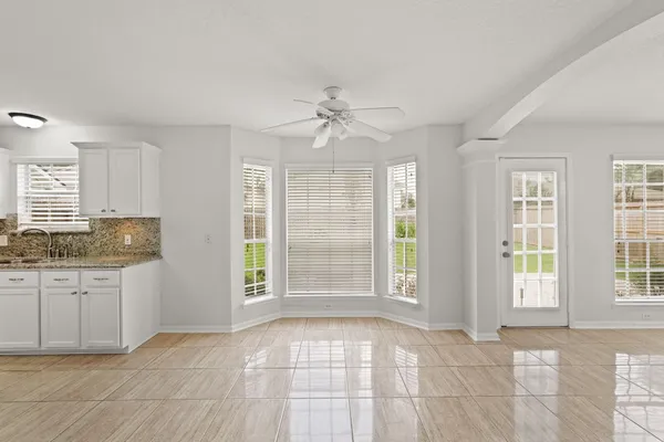 a view of an empty room with window and cabinet
