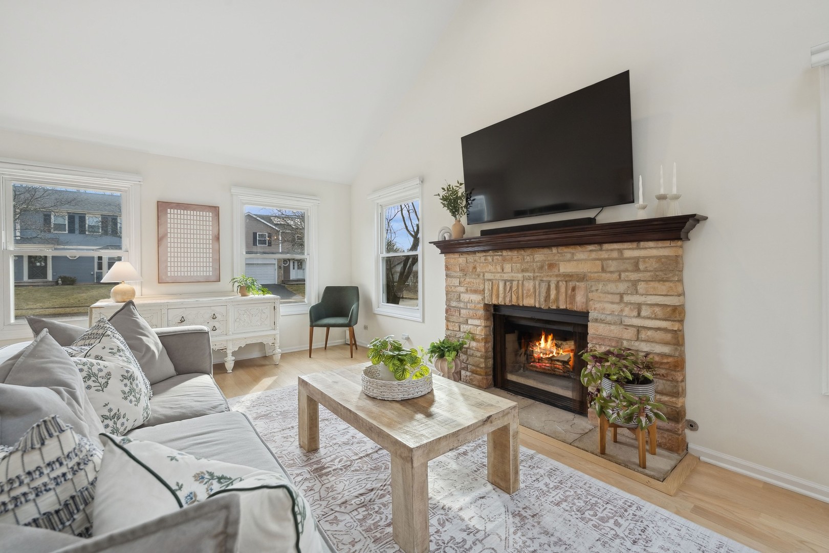 27W228 Churchill Road Winfield, IL 60190 - Photo 8 of 33 a living room with furniture a flat screen tv and a fireplace