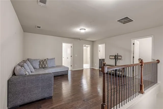 a spacious bedroom with a bed and a chandelier