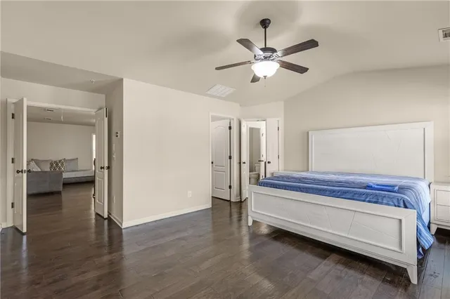 a spacious bedroom with a bed and a window