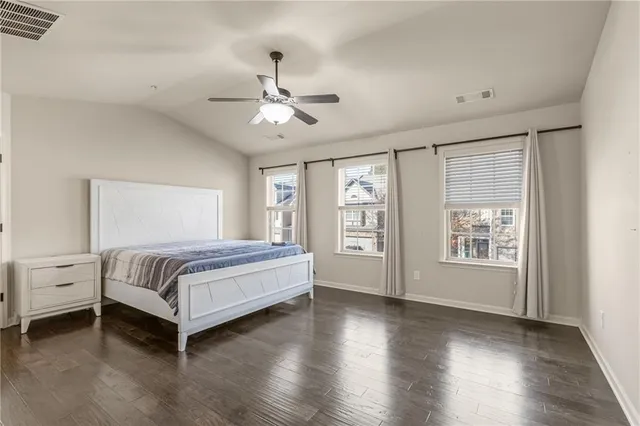 a bedroom with a large bed and window