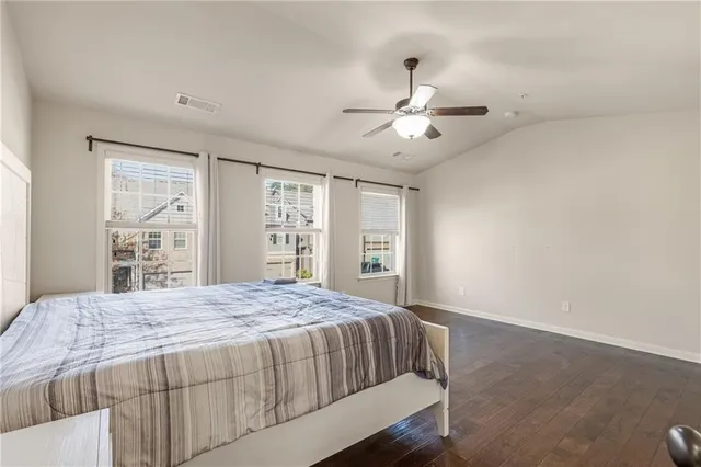 a spacious bathroom with a granite countertop sink a toilet and a mirror