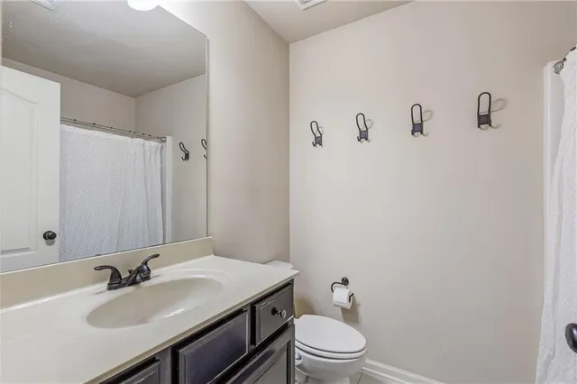 a bathroom with a sink a toilet and mirror
