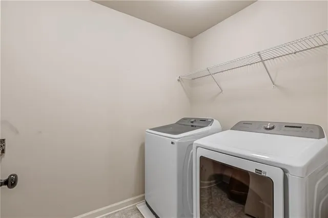 a view of a yard with wooden fence