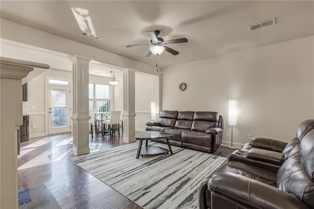 a living room with furniture and a chandelier