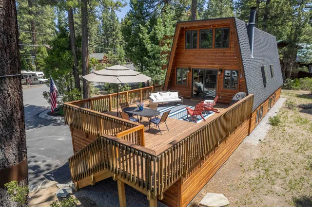 a view of a balcony with two chairs and a deck