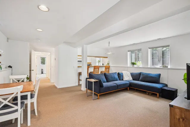 a kitchen with a sink a counter and chairs