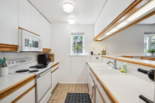 a bedroom with a bed and windows