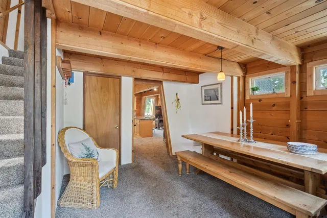 a hallway with furniture and a large window