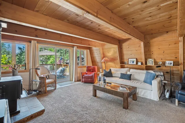 a living room with furniture and a floor to ceiling window