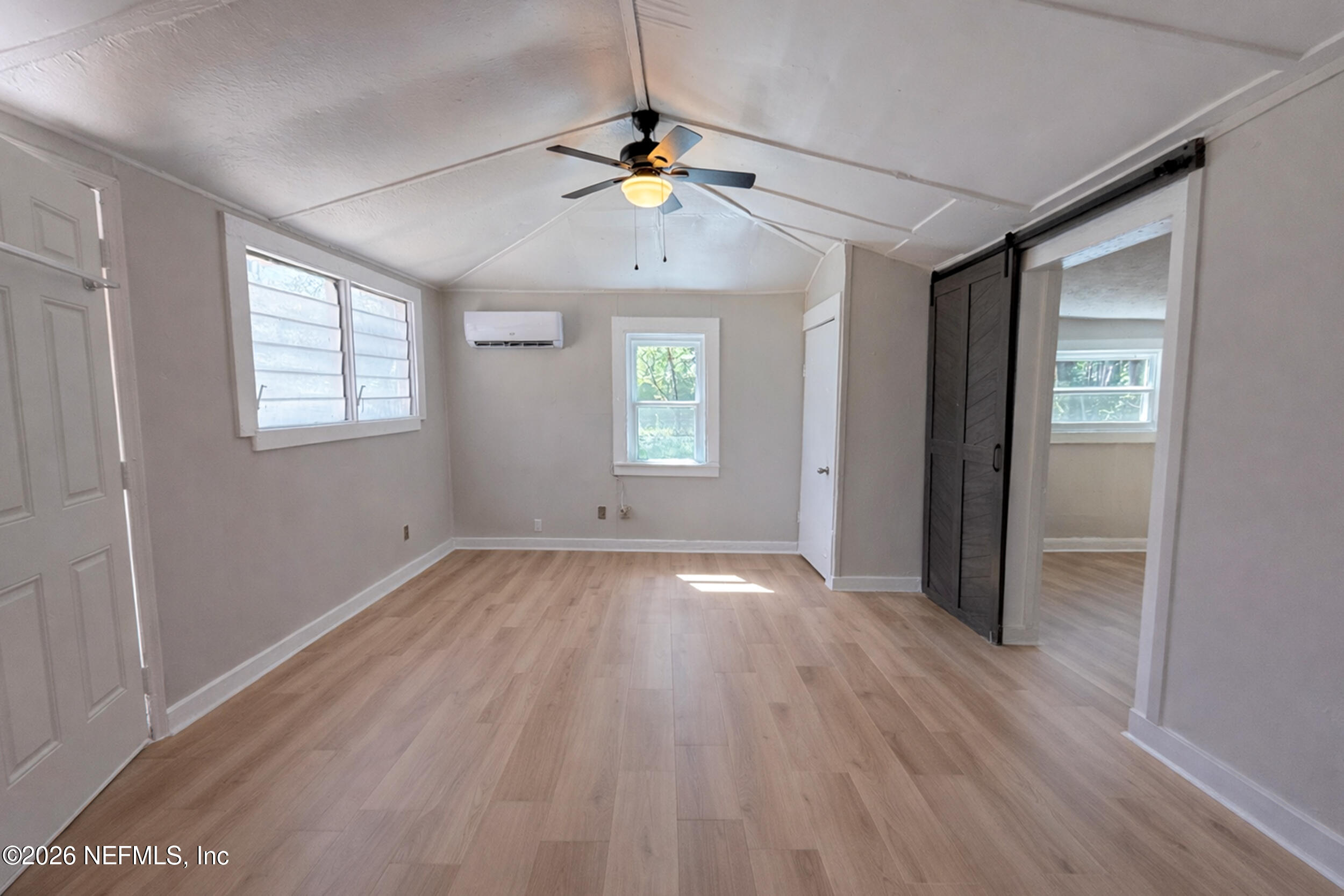 6300 Blanchard Road Jacksonville, FL 32216 - Photo 4 of 12 a view of an empty room with wooden floor and a window