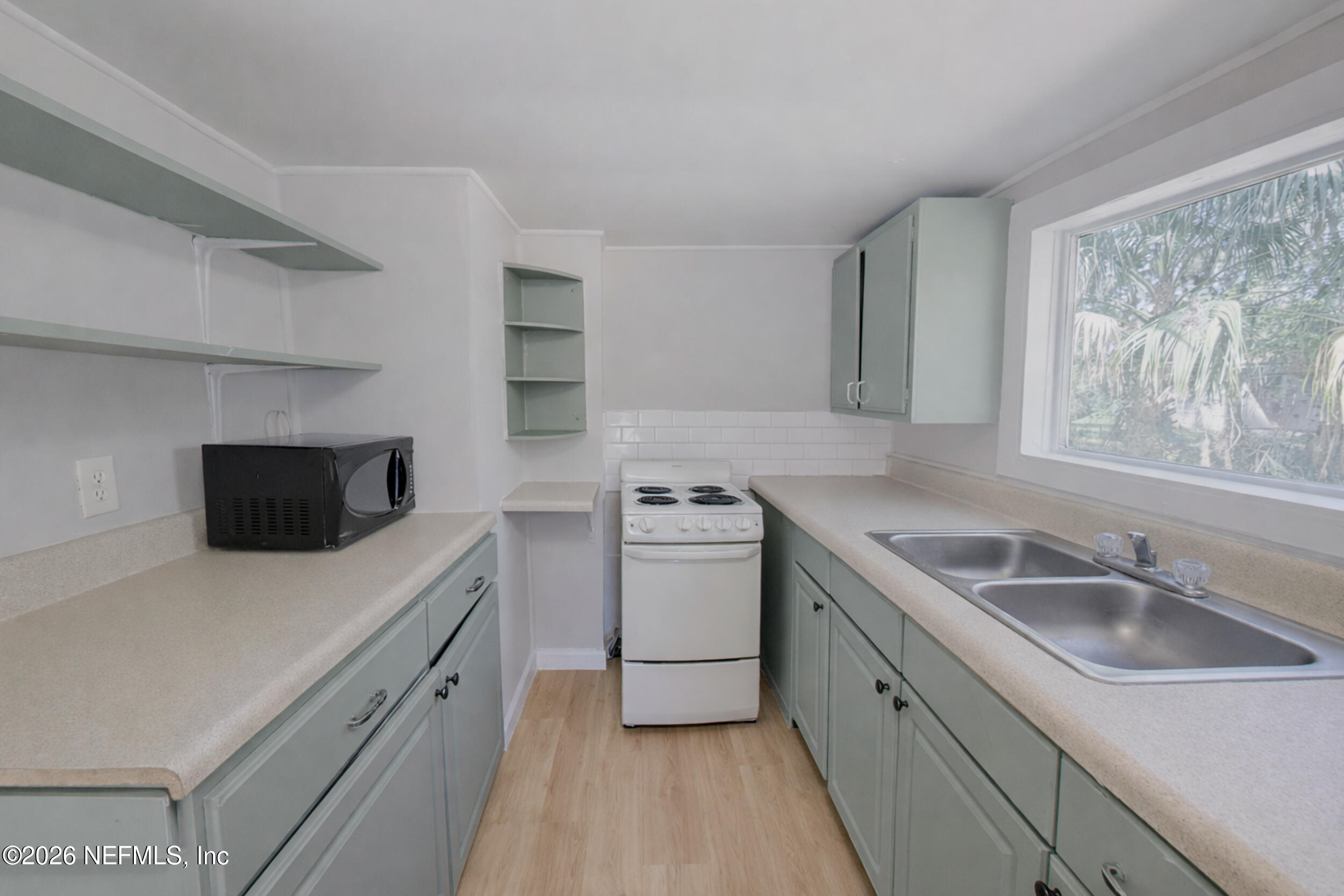 6300 Blanchard Road Jacksonville, FL 32216 - Photo 7 of 12 a kitchen with a sink stove and microwave