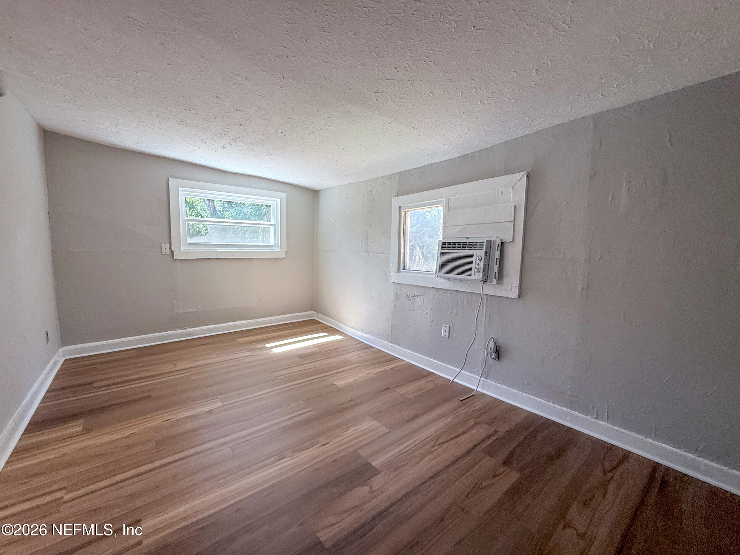 6300 Blanchard Road Jacksonville, FL 32216 - Photo 8 of 12 a view of empty room with wooden floor and fan