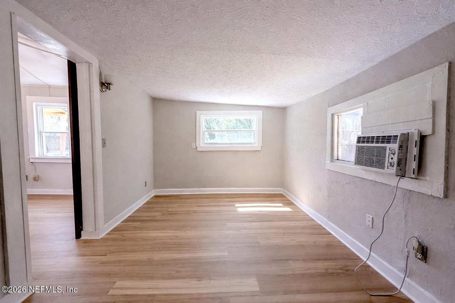 6300 Blanchard Road Jacksonville, FL 32216 - Photo 10 of 12 a view of an empty room with window and wooden floor