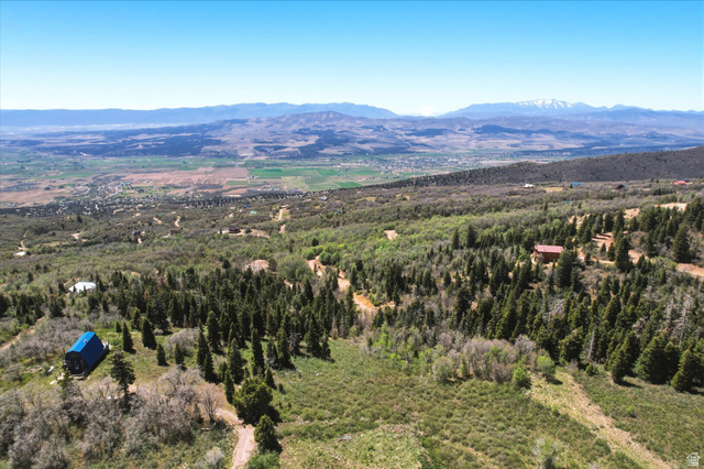 14255 Main Road, Unit G3 Fairview, UT 84629 - Photo 3 of 5 Expansive property featuring mature coniferous and deciduous trees, mountainous terrain, distant mountain ranges, and scattered residential structures
