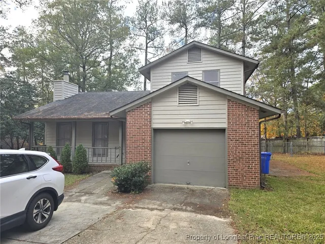 a car parked in front of white house