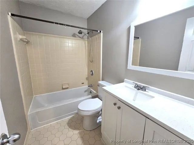 a bathroom with a sink toilet a mirror and shower