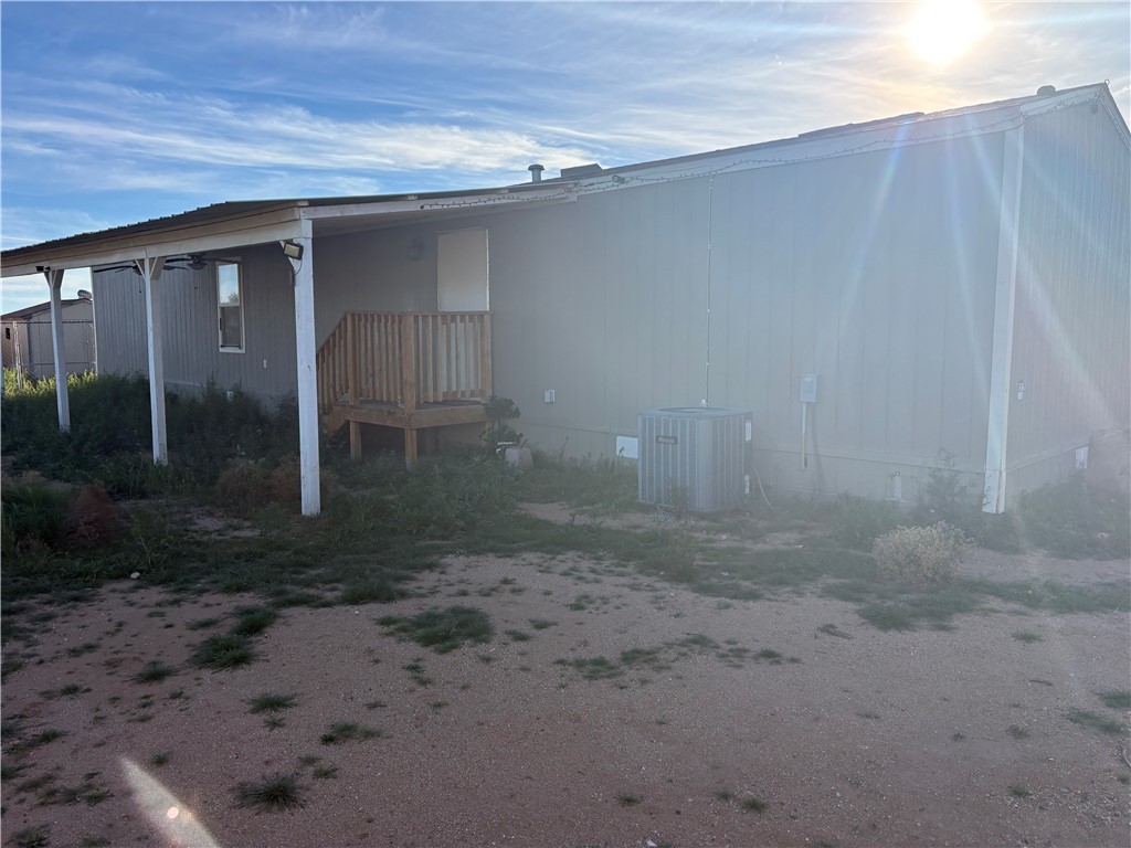 4938 Mormon Flat Road Golden Valley, AZ 86413 - Photo 18 of 23 View of side of property featuring a central air condition unit